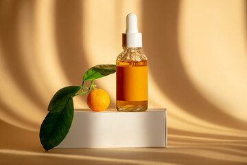 Glass bottle with an orange oil dropper for skin, hair. Packaging with serum on brown background in...