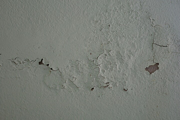 The wall has peeling paint due to time and aging.