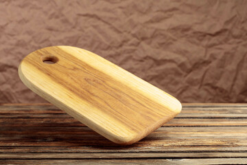 Cutting board falling on an old wooden table.