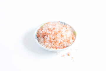 Himalayan pink salt (rock salt, halite mined) in white bowl  isolated on white background.