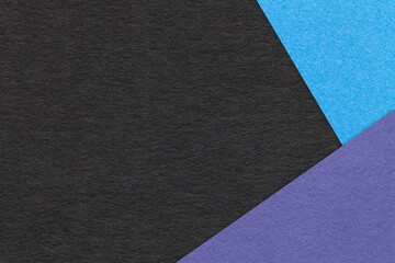 Texture of craft black color paper background with blue and violet border. Vintage abstract cardboard.