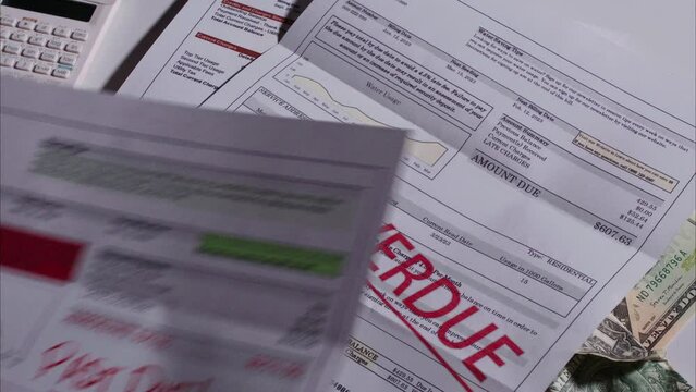 Past Due Bills Fall Down One by One - Gas, Electricity, Water, Phone Bills. Shot with ARRI Alexa in ARRIRAW at 23.98 fps and exported QuickTime Apple Pro Res 422 HQ.