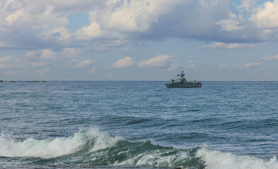 military ship on the background of clouds