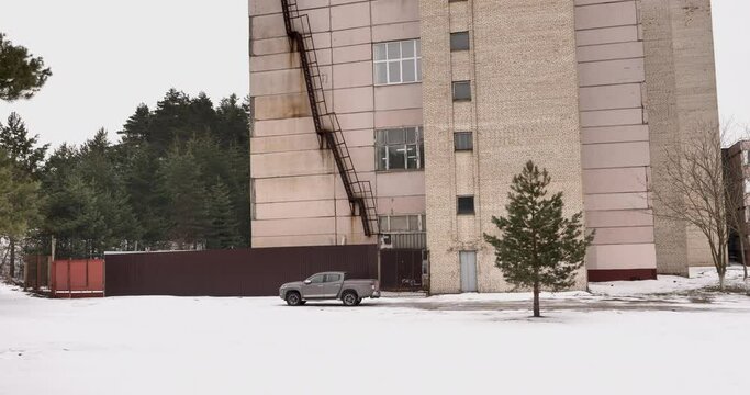 Abandoned Scientific Research Institute in the Winter Forest: Pickup Truck Parked in Front of the Neglected Building