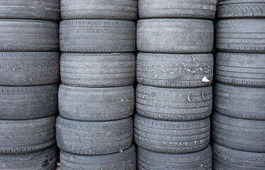 A pile of stacked worn racing car tires