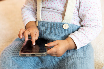 Baby holding a mobile phone