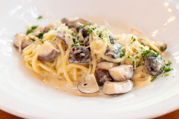Vegan spaghetti mushroom carbonara on white plate.