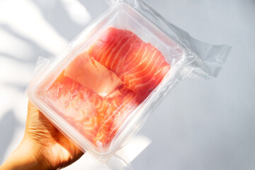 Fresh salmon and toro sashimi in vacuum package on hand.