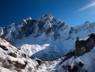 A majestic mountain range with snow-capped peaks and a clear blue sky