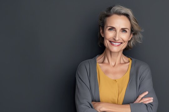 Mature woman smiling confidently on grey wall. Photo generative AI