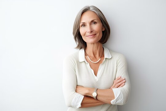 Elegant middle-aged woman arms crossed on white. Photo generative AI