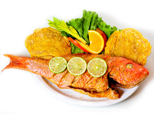 A plate of Colombian favorites, including fish, pies and vegetables