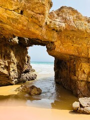 Rock arch formation on the beach at Praia das Furnas on the Algarve, Portugal