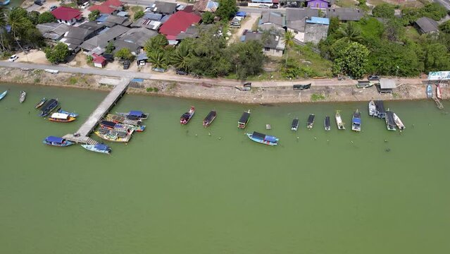 Aerial moving backward, traditional colorful Asian fisherman village in Besut, Terengganu, Malaysia. 4K