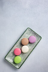 Pile of Macaroon or Macaron Biscuits on Grey Background
