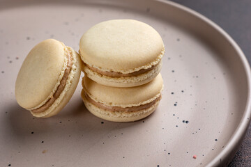 Macaroons on a plate with a dark background