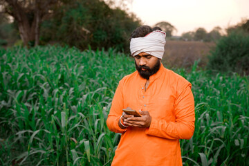 Young indian farmer working at field