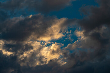 Naklejka na ściany i meble Beautiful dramatic sky with sunbeams through the clouds at sunset