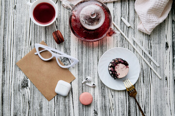 Feminine aesthetics pink healthy dessert with natural tea, earphones and envelope mock up. Women lifestyle background
