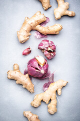 Fresh ginger root and purple garlic. Gray kitchen table background, top view
