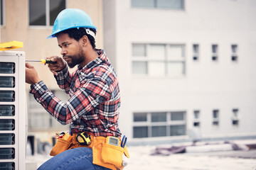 Black man, electrician and maintenance with engineering and ac repair with handyman working with tools on roof. Fix air conditioner, male technician with screwdriver and power generator with service