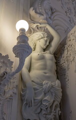 An ancient sculpture of a beautiful caryatid woman with a lantern