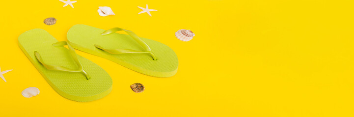 Beach accessories. Flip flops and starfish on colored background. Top view Mock up with copy space