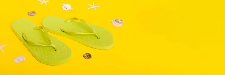  Beach accessories. Flip flops and starfish on colored background. Top view Mock up with copy space © sosiukin