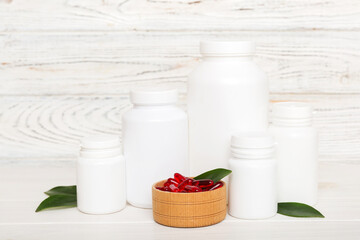 different drugs and health supplement pills with medicine bottle health care and medical top view. Vitamin tablets. Bottle with colored pills on table background. Multivitamins