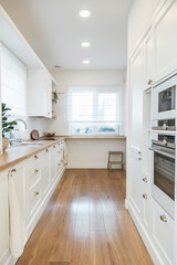 Bright spacious white kitchen made in classic style