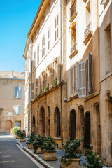 A vibrant street in Aix-en-Provence, France featuring an old church with a beautiful half-timbered...