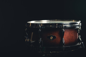 Fototapeta na wymiar Beautiful snare drum on a black background, close up.
