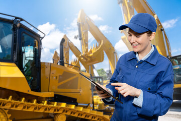 Woman with digital tablet on the background of construction machines	