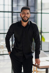 Portrait of successful businessman standing in office