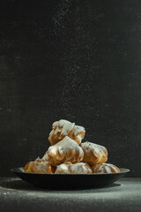 cookies and cake on a dark black background
