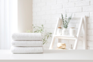 Spa towel stack on white table on bathroom interior background - obrazy, fototapety, plakaty