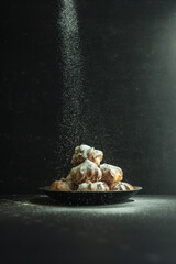 cookies and cake on a dark black background
