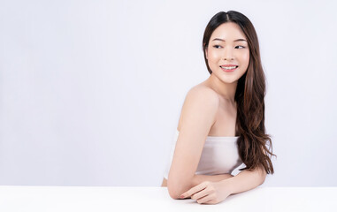 Obraz premium Closeup portrait of beauty asian woman with fair perfect healthy glow skin hand touch shoulder copy space, young beautiful asia girl with pretty smile on face. Beauty korean clinic skincare banner