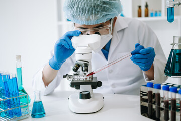 Male scientist researcher conducting an experiment in laboratory..