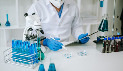 Scientist mixing chemical liquids in the chemistry lab. Researcher working in the laboratory