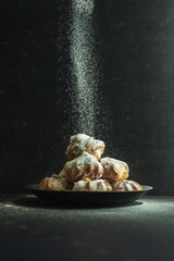 cookies and cake on a dark black background
