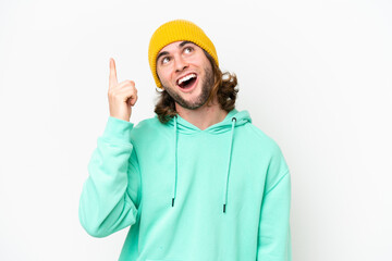 Young handsome man isolated on white chroma background pointing up and surprised