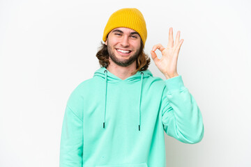 Young handsome man isolated on white chroma background showing ok sign with fingers