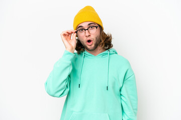 Young handsome man isolated on white chroma background with glasses and surprised