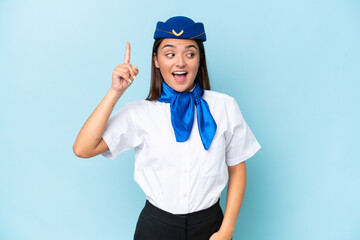 Airplane stewardess caucasian woman isolated on blue background intending to realizes the solution while lifting a finger up