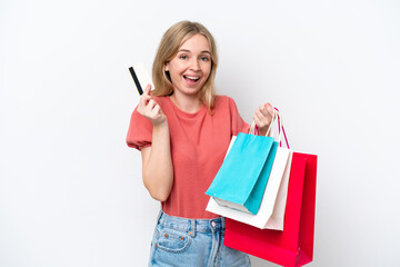 Fototapeta premium Young English woman isolated on white background holding shopping bags and a credit card