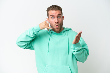 Young handsome caucasian man isolated on white background making phone gesture and doubting