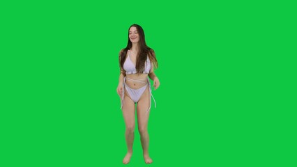 Stunning model in white bikini dancing in front of a green screen - Powered by Adobe