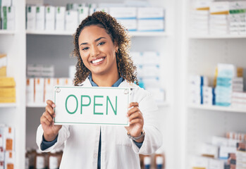 Open, business sign and woman portrait in a pharmacy with billboard from medical work. Working, pharmacist and healthcare worker with a smile from retail store opening and small business poster