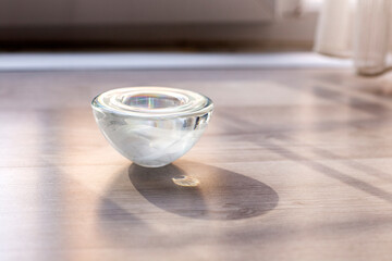 Crystal candle holder on the wooden floor isolated 